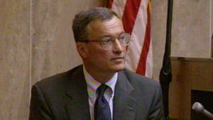 A man in a suit testifies in court