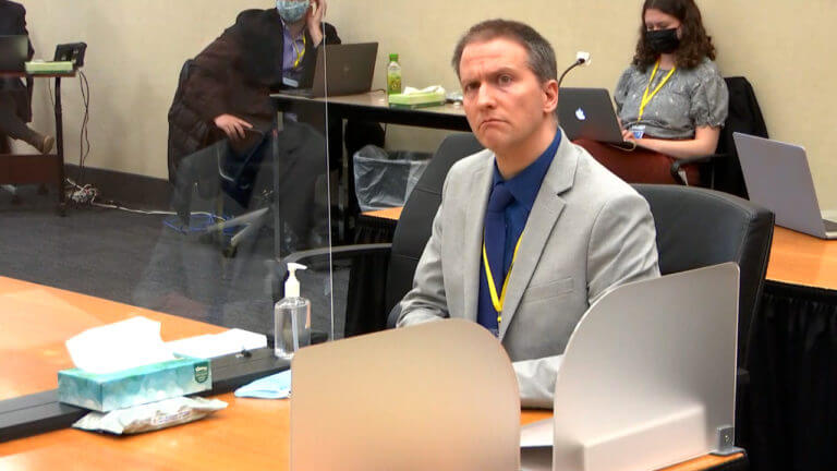 Derek Chauvin listens as his defense attorney Eric Nelson gives closing arguments