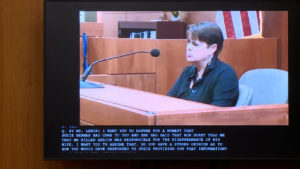 A woman appears in prerecorded testimony