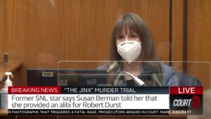 a woman wearing a facemask testifies in court