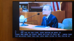 a man appears in videotaped testimony