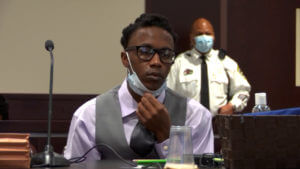 Defendant Everett listens in court during his murder trial