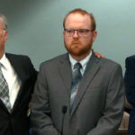 Travis McMichael stands as the judge reads the jury's verdict in the Glynn County Courthouse