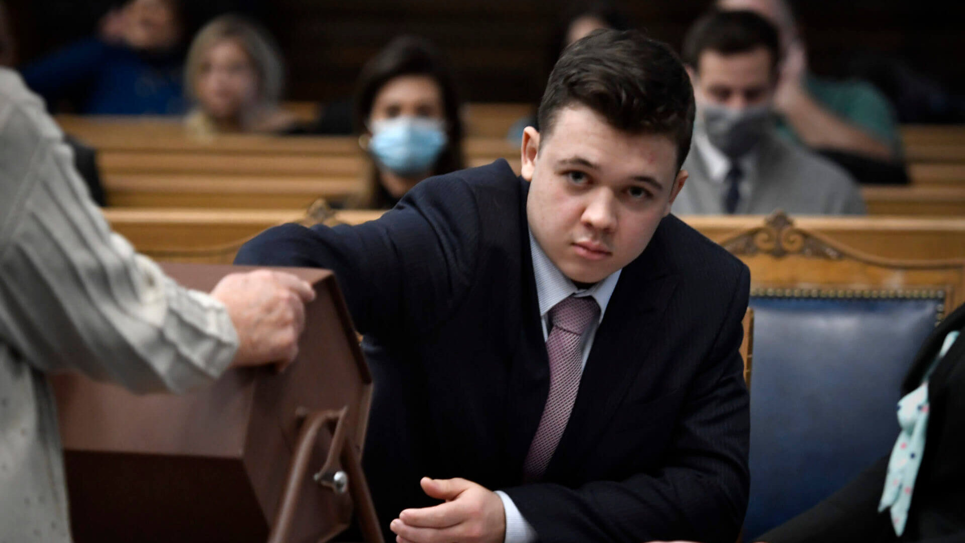 man reaches hand in box