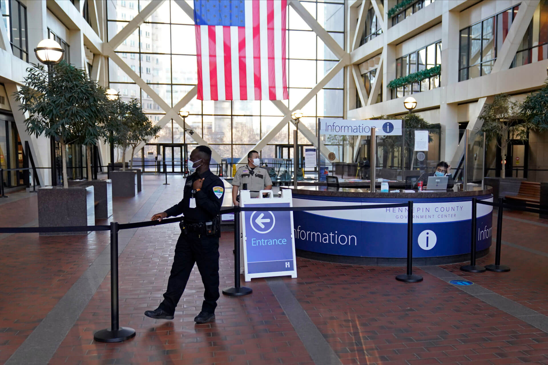 security guard stands next to the cordoned off atrium