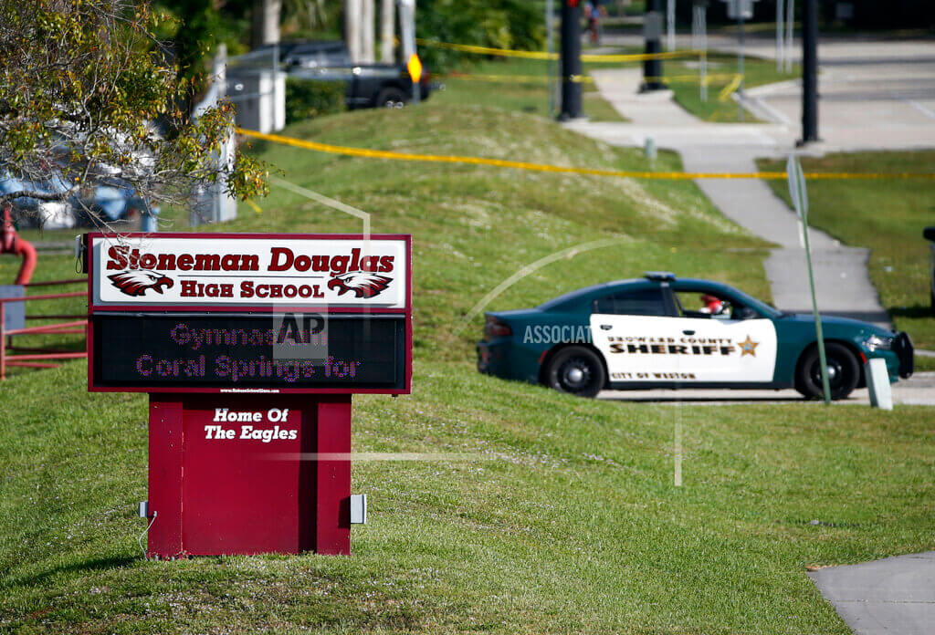 police cruiser with sign for marjory stoneman douglas high school