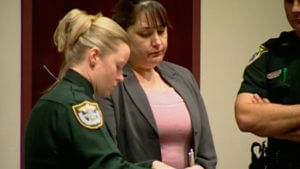 Karen Tobie is fingerprinted after being found guilty in the death of her husband