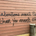 Threatening graffiti is seen on the exterior of Wisconsin Family Action offices