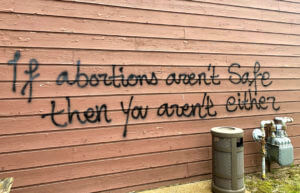 Threatening graffiti is seen on the exterior of Wisconsin Family Action offices