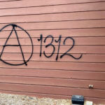 Threatening graffiti is seen on the exterior of Wisconsin Family Action offices