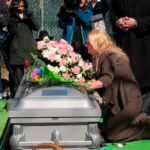 Mari Gilbert prays over the coffin of her daughter, Shannan Gilbert