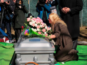 Mari Gilbert prays over the coffin of her daughter, Shannan Gilbert