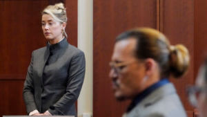 Actors Amber Heard and Johnny Depp watch as the jury leave the courtroom