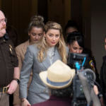 Amber Heard walks out of the Fairfax County courthouse.