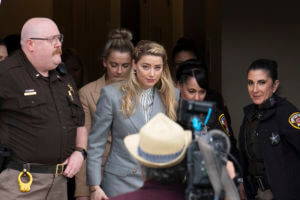 Amber Heard walks out of the Fairfax County courthouse.