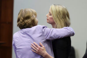 Amber Heard hugs her lawyer Elaine Bredehoft after the verdict