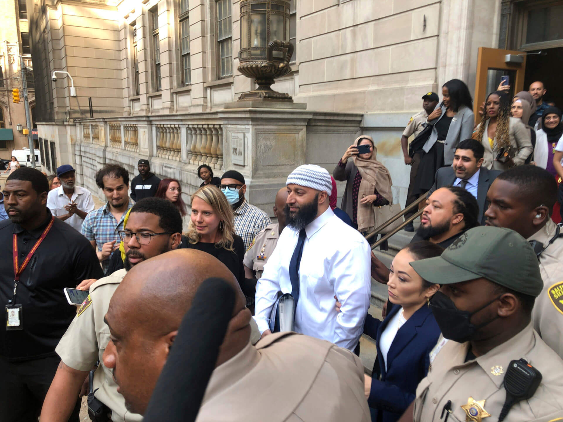 Adnan Syed, center, leaves the Elijah E. Cummings Courthouse