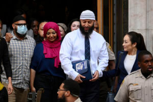 Adnan Syed, center right, leaves the courthouse after the hearing