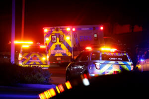 Ambulance and police cars flash lights at night