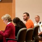 Adam Montgomery, with defense attorneys Caroline Smith, far left, and Paige Pihl-Buckley listens during a hearing