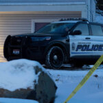 Police outside of a house with snow