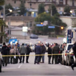 Law enforcement personnel gather outside a ballroom dance club in Monterey Park