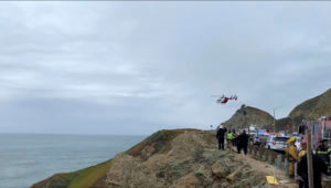 emergency personnel respond to the scene after a Tesla plunged off a cliff along the Pacific Coast Highway, Monday, Jan. 2