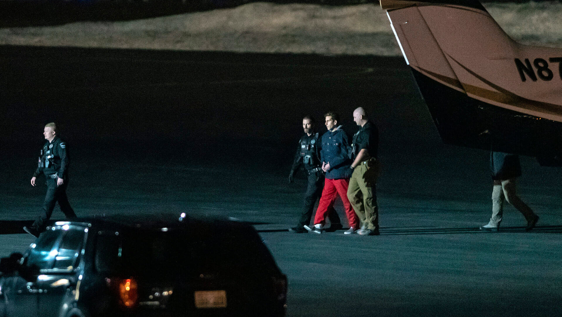 Bryan Kohberger is escorted by law enforcement after arriving at Pullman-Moscow Regional Airport
