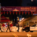 FBI agents walk near a scene where a shooting took place in Monterey Park