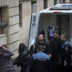 Andrew Tate and his brother Tristan are brought by police officers to the Court of Appeal, in Bucharest, Romania