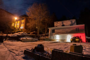 A private security officer sits in a vehicle, Tuesday, Jan. 3, 2023, in front of the house in Moscow, Idaho where four University of Idaho students were killed