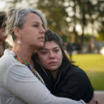 Jolie Slater, right, and Beth Paz, from Lake Avenue Church, embrace each other