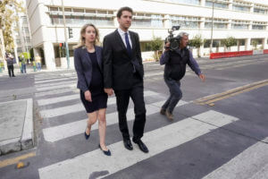 Former Theranos CEO Elizabeth Holmes, left, walks with her partner, Billy Evans