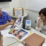 Hawaii Innocence Project co-director Kenneth Lawson, background center, and law students go over files and photos related to the 1991 murder of Dana Ireland in Honolulu