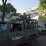 A heavily armed army convoy departs the prosecutor's building where Ovidio Guzmán is in custody