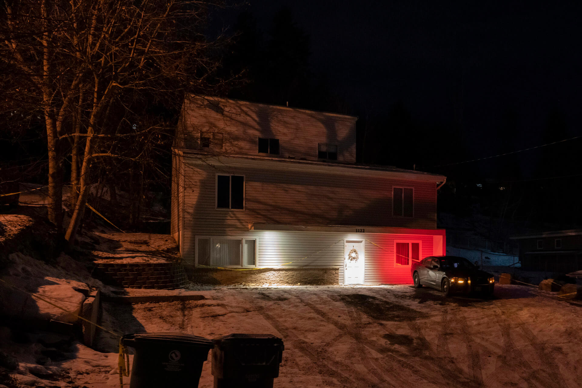 A private security officer sits in a vehicle, Tuesday, Jan. 3, 2023, in front of the house in Moscow, Idaho where four University of Idaho students were killed