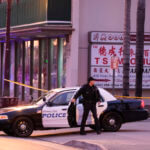 A police officer gets out of his vehicle near a ballroom dance club in Monterey Park