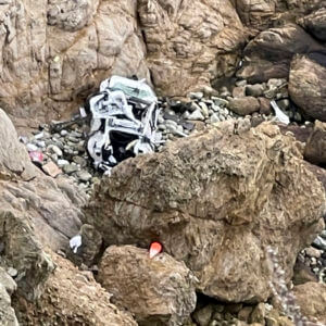 emergency personnel respond to the scene after a Tesla plunged off a cliff along the Pacific Coast Highway, Monday, Jan. 2