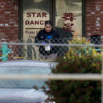 An investigator carries markers outside Star Dance Studio