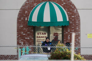 Investigators are seen outside Star Dance Studio in Monterey Park, Calif., Sunday, Jan. 22, 2023