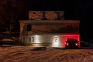 A private security officer sits in a vehicle, Tuesday, Jan. 3, 2023, in front of the house in Moscow, Idaho where four University of Idaho students were killed