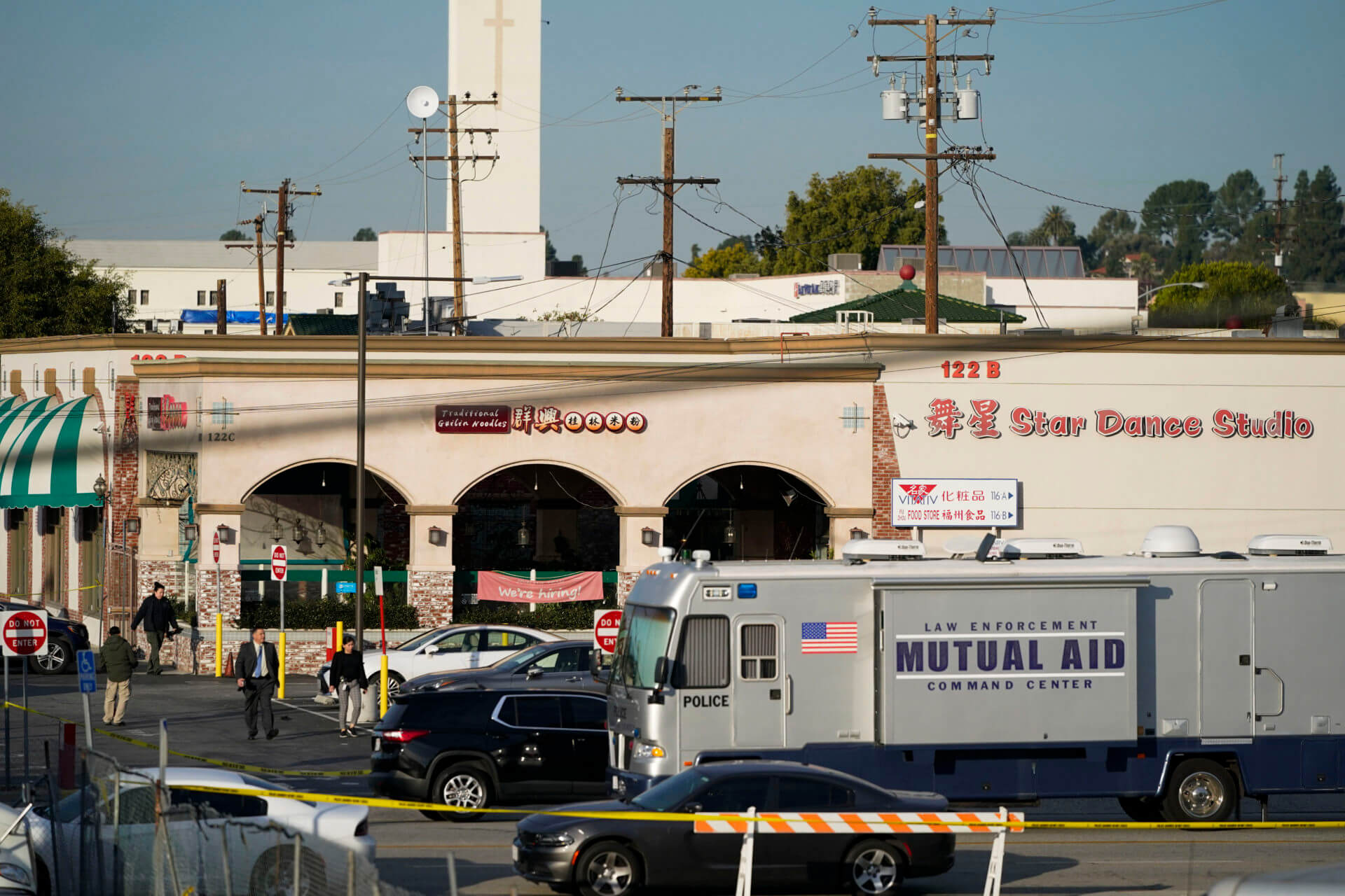 Investigators are seen outside Star Dance Studio in Monterey Park, Calif., Sunday, Jan. 22, 2023