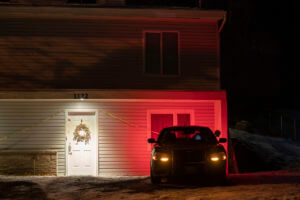 A private security officer sits in a vehicle, Tuesday, Jan. 3, 2023, in front of the house in Moscow, Idaho where four University of Idaho students were killed