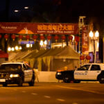 Two police vehicles are seen near a building where a shooting occurred in Monterey Park