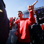 Stetson Bennett walks the route during a parade