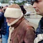 Matteo Messina Denaro, center, leaves an Italian Carabinieri barrack soon after his arrest at a private clinic in Palermo