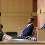 Shooting suspect Michael Boatwright, right, and alleged accomplices, Dedrick Williams, left, and Trayvon Newsome, look towards the courtroom door during a hearing