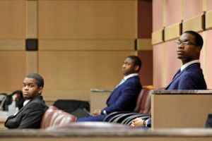 Shooting suspect Michael Boatwright, right, and alleged accomplices, Dedrick Williams, left, and Trayvon Newsome, look towards the courtroom door during a hearing