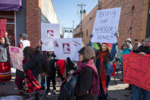 People participate in a march in downtown Rapid City, S.D., Thursday, Feb. 14, 2019