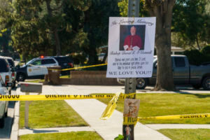 An image of Bishop David O'Connell is posted on the post of a street sign near his home